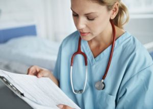 Travel nurse reading a contract, Travel Nurse Tips From Recruiters