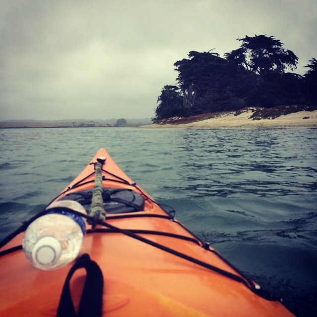 view of the lake on a cloudy day from an orange kayak 